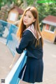 A woman in a school uniform posing for a picture.