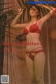 A woman in a red lingerie posing for a picture.