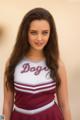 A young woman in a cheerleading uniform posing for a picture.