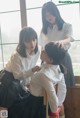 A group of young women in school uniforms standing next to each other.