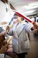 A woman holding a sword in a store.